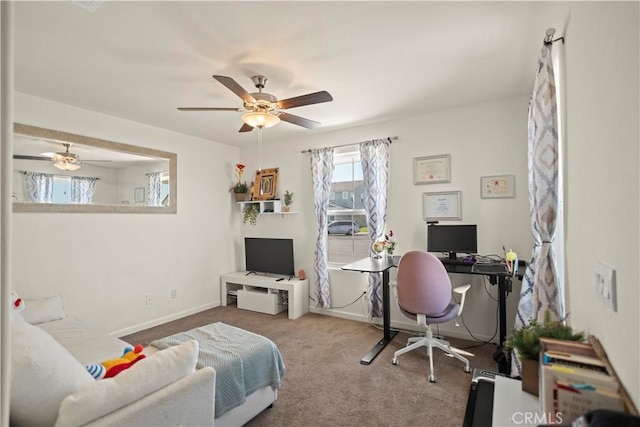 carpeted office space featuring baseboards and a ceiling fan
