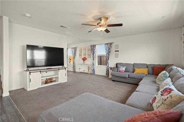 carpeted living room featuring ceiling fan, baseboards, and visible vents