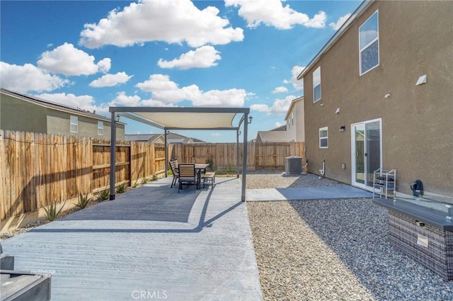 view of patio featuring outdoor dining space, a fenced backyard, and central AC
