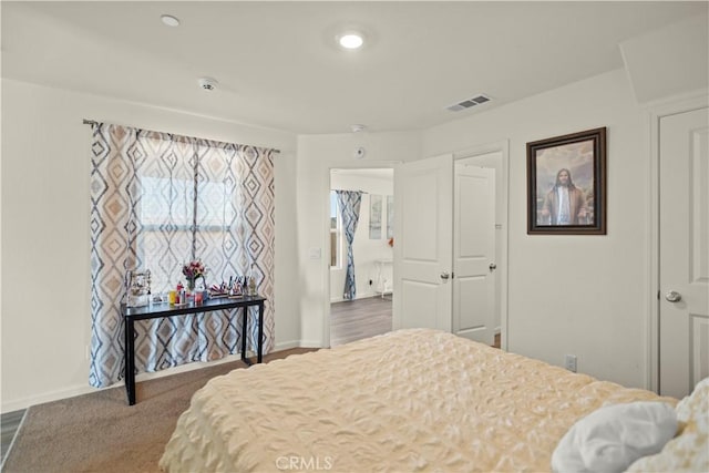 bedroom with visible vents and baseboards