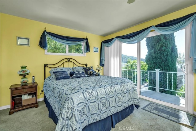 bedroom with access to exterior, baseboards, and carpet floors