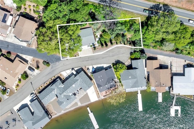 drone / aerial view featuring a water view and a residential view