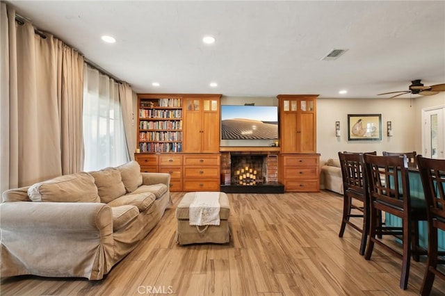 3251 Woodstock Rd, Rossmoor, CA 90720 - living room featuring recessed lighting, a fireplace, visible vents, and light wood-type flooring