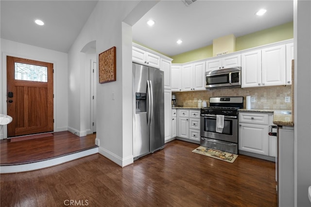 1753 Filbert St, Paso Robles, CA 93446 - kitchen featuring white cabinets, decorative backsplash, light stone countertops, dark wood-type flooring, and appliances with stainless steel finishes