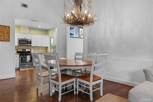 1753 Filbert St, Paso Robles, CA 93446 - dining area featuring baseboards, visible vents, arched walkways, and dark wood-style flooring