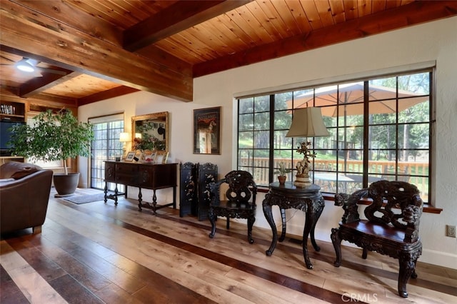 36575 Mudge Ranch Rd, Coarsegold, CA 93614 - living area featuring wooden ceiling, beamed ceiling, a wealth of natural light, and hardwood / wood-style flooring