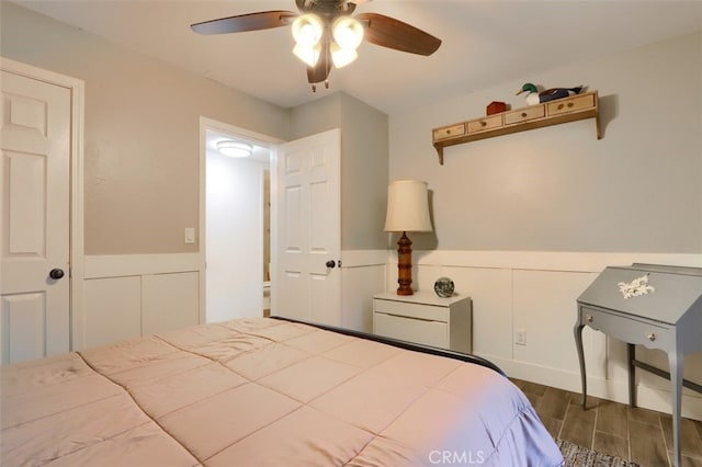36575 Mudge Ranch Rd, Coarsegold, CA 93614 - bedroom featuring a wainscoted wall, ceiling fan, and wood finished floors