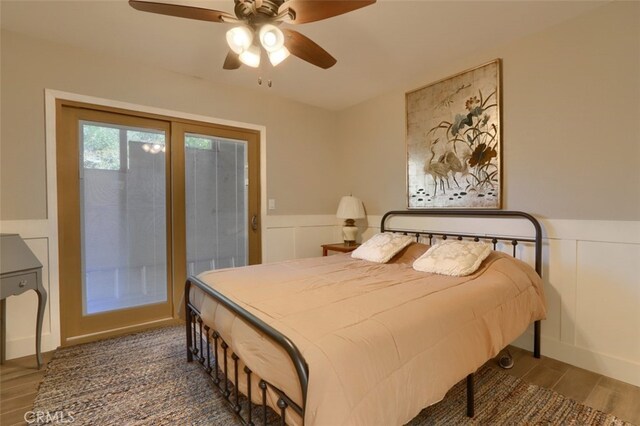 36575 Mudge Ranch Rd, Coarsegold, CA 93614 - bedroom featuring a decorative wall, access to exterior, and a wainscoted wall