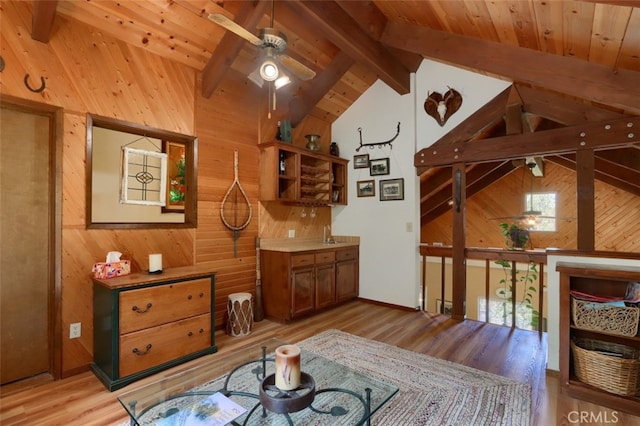 36575 Mudge Ranch Rd, Coarsegold, CA 93614 - interior space featuring wood walls, ceiling fan, light wood-style flooring, and lofted ceiling with beams