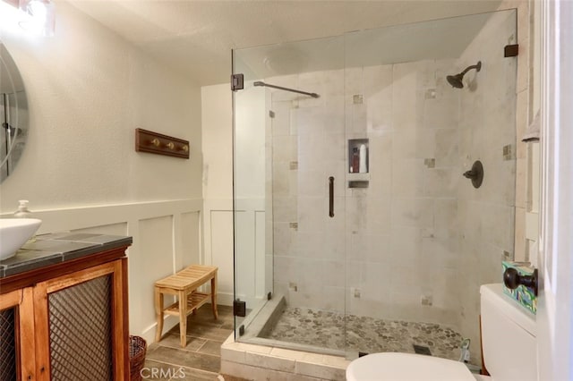 36575 Mudge Ranch Rd, Coarsegold, CA 93614 - full bath with a shower stall, vanity, toilet, and wainscoting
