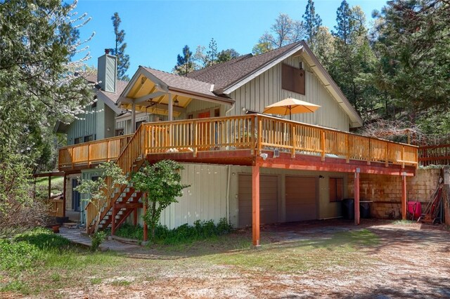 36575 Mudge Ranch Rd, Coarsegold, CA 93614 - rear view of house featuring a deck, an attached garage, a chimney, stairs, and driveway