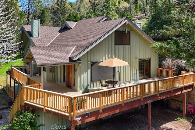 36575 Mudge Ranch Rd, Coarsegold, CA 93614 - back of property featuring roof with shingles, a deck, board and batten siding, and a chimney