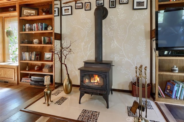 36575 Mudge Ranch Rd, Coarsegold, CA 93614 - living area featuring wallpapered walls, a wood stove, and wood-type flooring