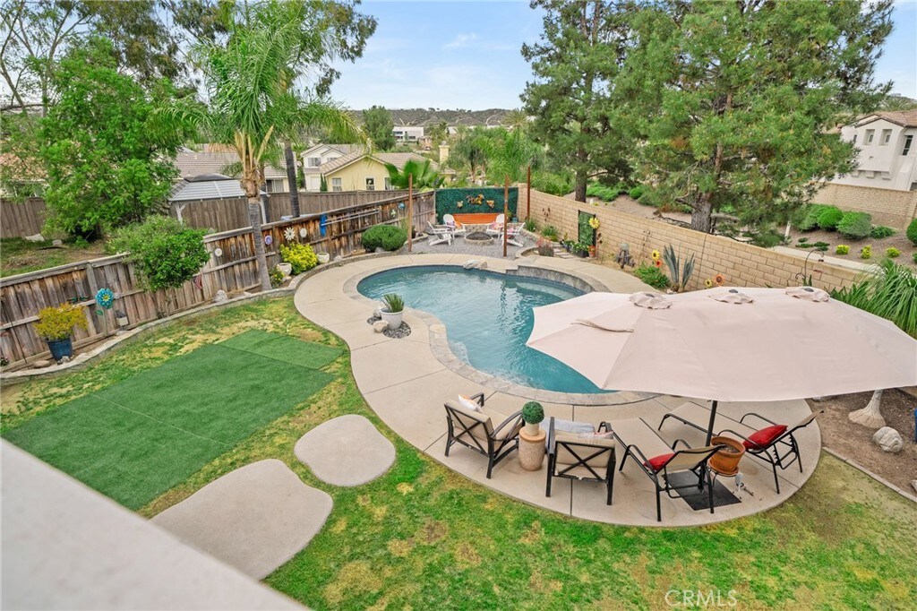 30204 Harvest Ln, Murrieta, CA 92563 - view of pool with a fenced in pool, a fenced backyard, a residential view, a patio area, and a lawn