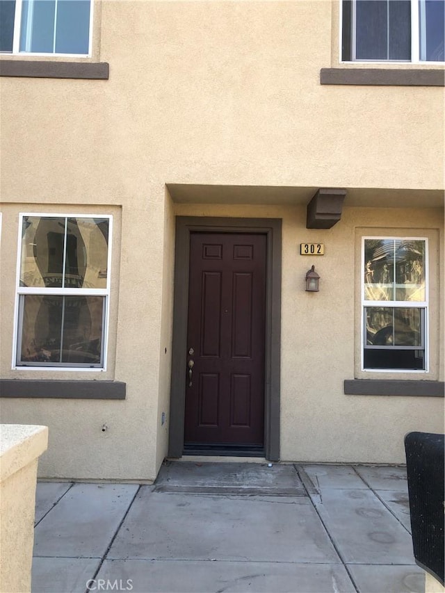 1800 E Lakeshore Dr Unit 302, Lake Elsinore, CA 92530 - view of exterior entry featuring stucco siding