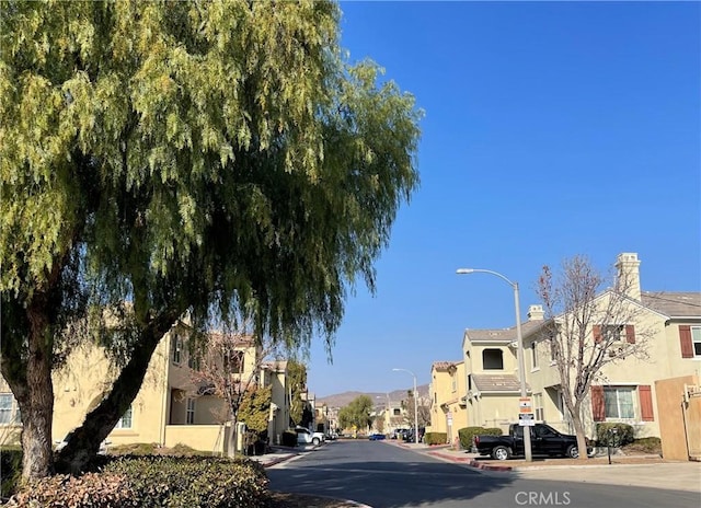 1800 E Lakeshore Dr Unit 302, Lake Elsinore, CA 92530 - view of street with street lighting, sidewalks, curbs, and a residential view