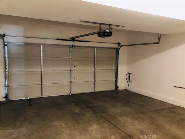 1800 E Lakeshore Dr Unit 302, Lake Elsinore, CA 92530 - garage featuring a garage door opener and baseboards