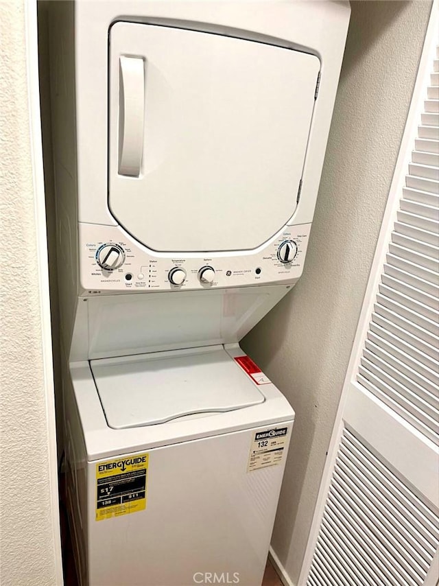 1800 E Lakeshore Dr Unit 302, Lake Elsinore, CA 92530 - washroom with laundry area, stacked washer and dryer, and a textured wall