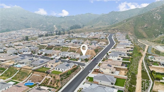 view of property location with nearby suburban area and mountains