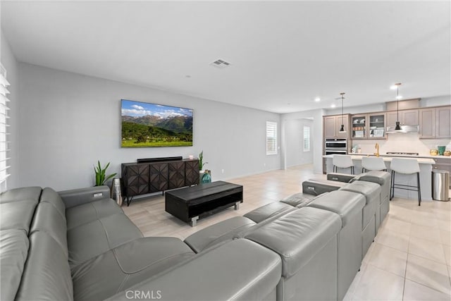 living area featuring light tile patterned floors and recessed lighting
