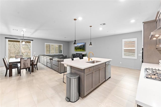 21123 Mill Valley Ct, Riverside, CA 92507 - kitchen with stainless steel appliances, light countertops, a kitchen island with sink, hanging light fixtures, and recessed lighting