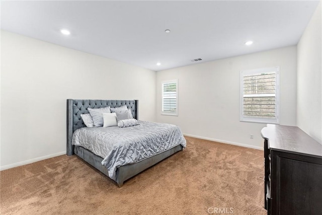 bedroom with light colored carpet, recessed lighting, and baseboards