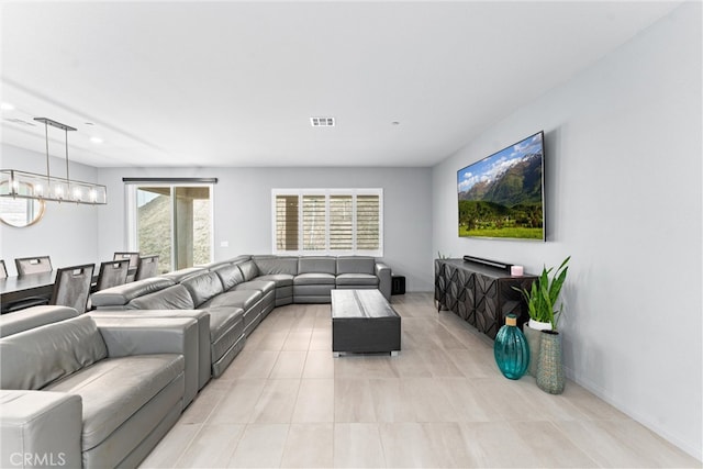 living room featuring recessed lighting, light tile patterned floors, and a chandelier