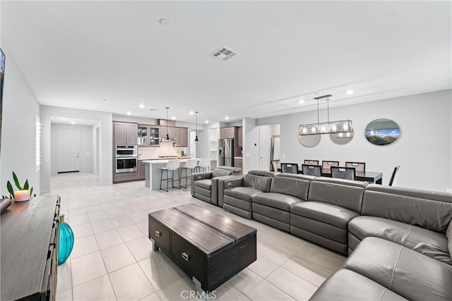 living area featuring light tile patterned flooring and recessed lighting