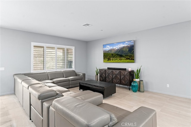 living room featuring light tile patterned floors and baseboards