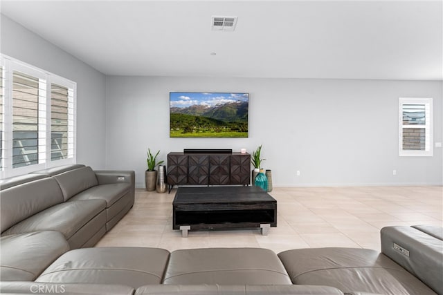 living room with healthy amount of natural light and light tile patterned flooring
