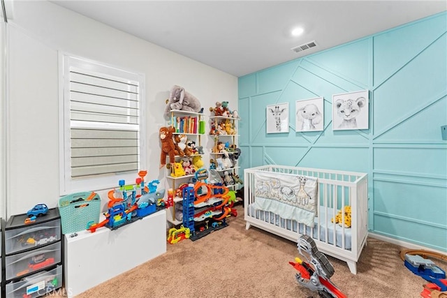 bedroom featuring carpet flooring and a crib