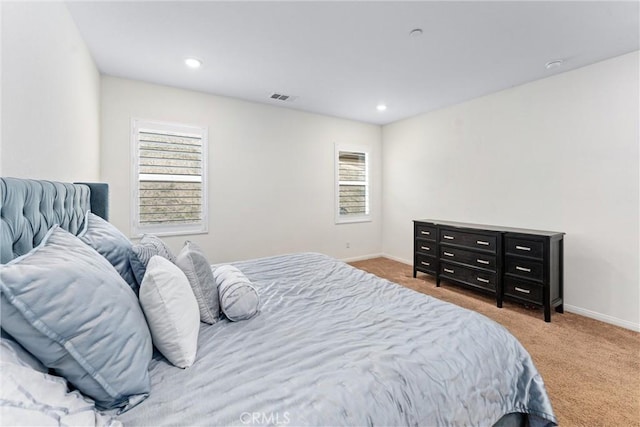 carpeted bedroom featuring multiple windows, baseboards, and recessed lighting