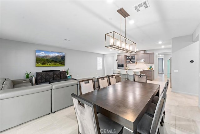 dining space with light tile patterned floors and recessed lighting