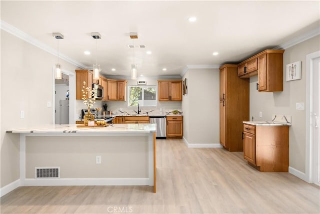 kitchen featuring visible vents, light wood-style floors, a peninsula, brown cabinetry, and stainless steel appliances