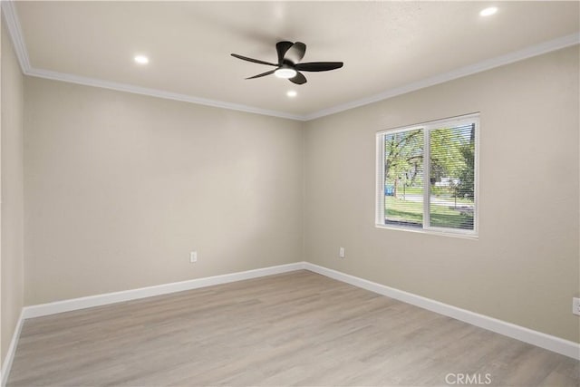 empty room with crown molding, baseboards, a ceiling fan, and light wood-style floors