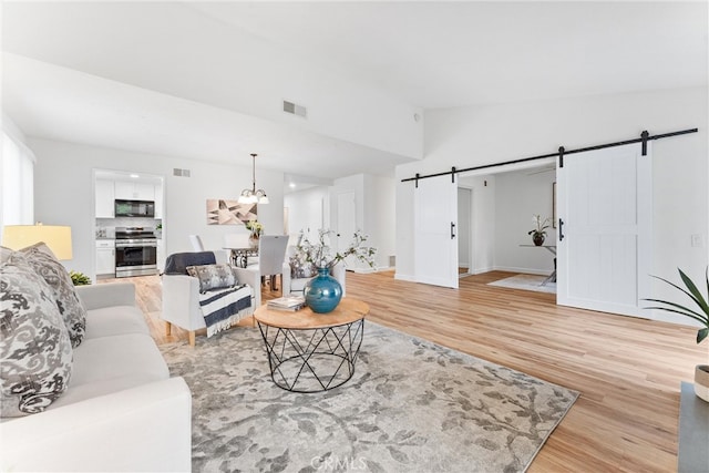 28133 Espinoza, Mission Viejo, CA 92692 - living area featuring light wood-style flooring, visible vents, and a barn door