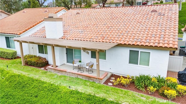 28133 Espinoza, Mission Viejo, CA 92692 - back of house with a yard, a chimney, a tiled roof, and stucco siding