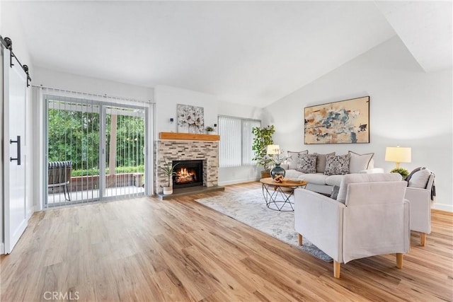 28133 Espinoza, Mission Viejo, CA 92692 - living room featuring vaulted ceiling, wood finished floors, and a lit fireplace