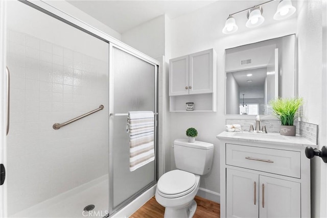 28133 Espinoza, Mission Viejo, CA 92692 - bathroom featuring toilet, a stall shower, visible vents, wood finished floors, and vanity