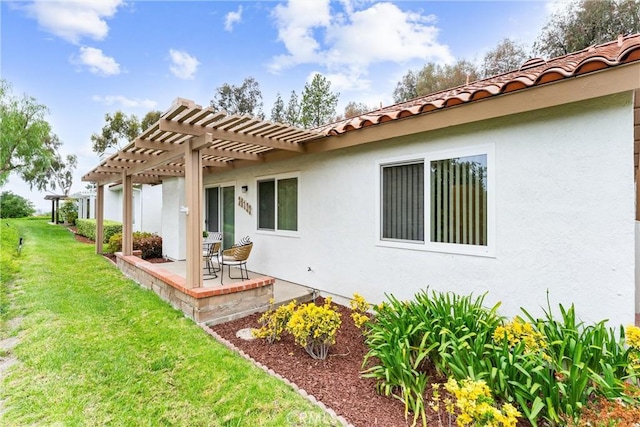 28133 Espinoza, Mission Viejo, CA 92692 - back of house with a pergola, stucco siding, a tile roof, a patio, and a lawn
