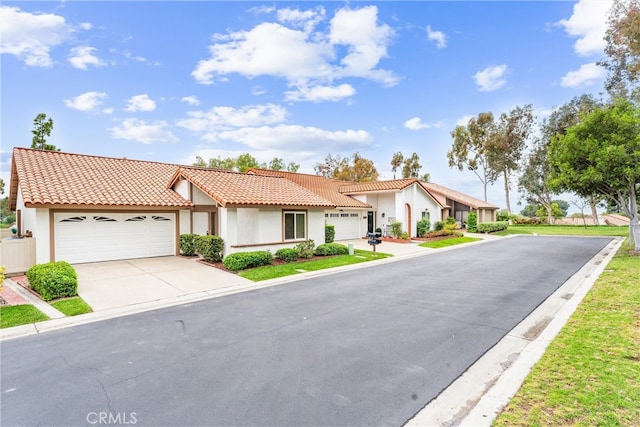 28133 Espinoza, Mission Viejo, CA 92692 - view of front facade featuring a garage, a tile roof, concrete driveway, and stucco siding