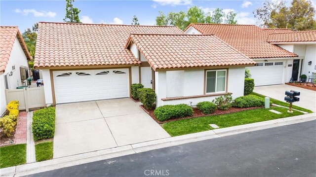 28133 Espinoza, Mission Viejo, CA 92692 - mediterranean / spanish-style house with a tile roof, a garage, driveway, and stucco siding