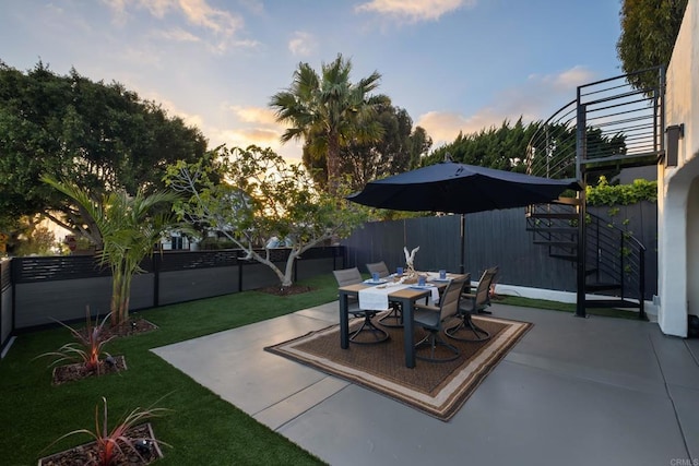 patio terrace at dusk with outdoor dining area