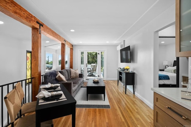 living area featuring light wood-style flooring, recessed lighting, and baseboards
