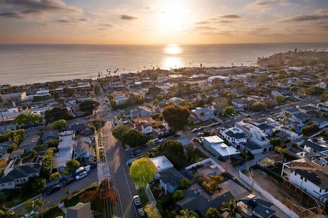 aerial view of property's location with a nearby body of water and nearby suburban area