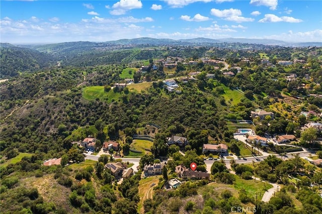 bird's eye view featuring a mountain view and a wooded view