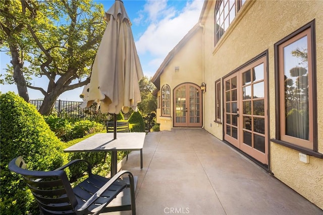 view of patio / terrace featuring french doors and fence