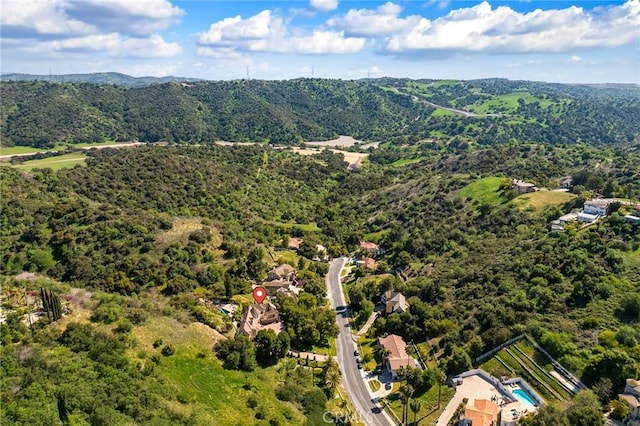 birds eye view of property with a view of trees