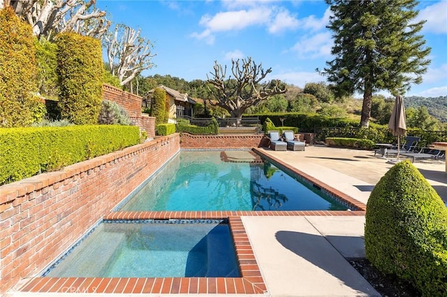 view of pool featuring a fenced in pool, a patio area, fence, and an in ground hot tub