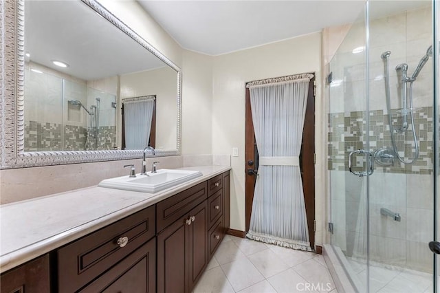 full bathroom with tile patterned floors, a shower stall, and vanity